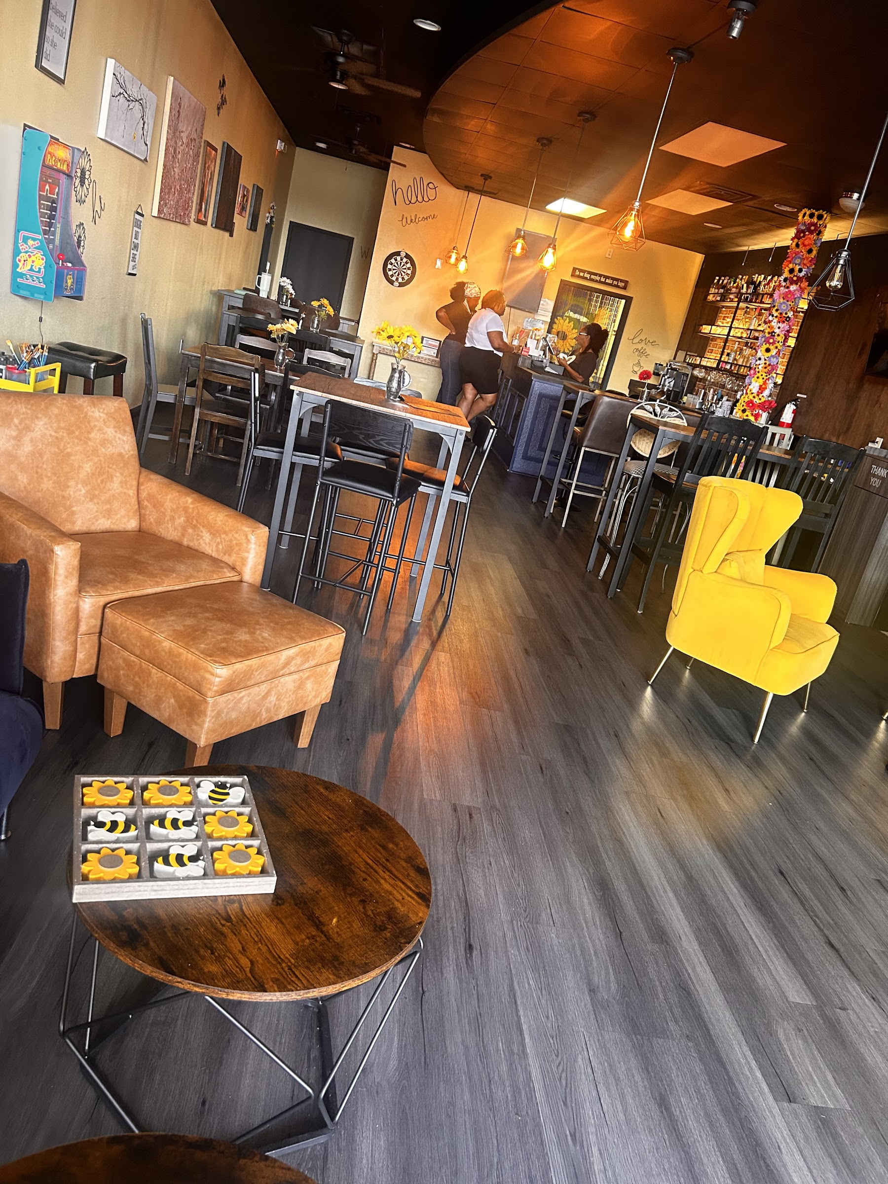 Cozy coffeehouse interior with yellow chair and bee-themed game