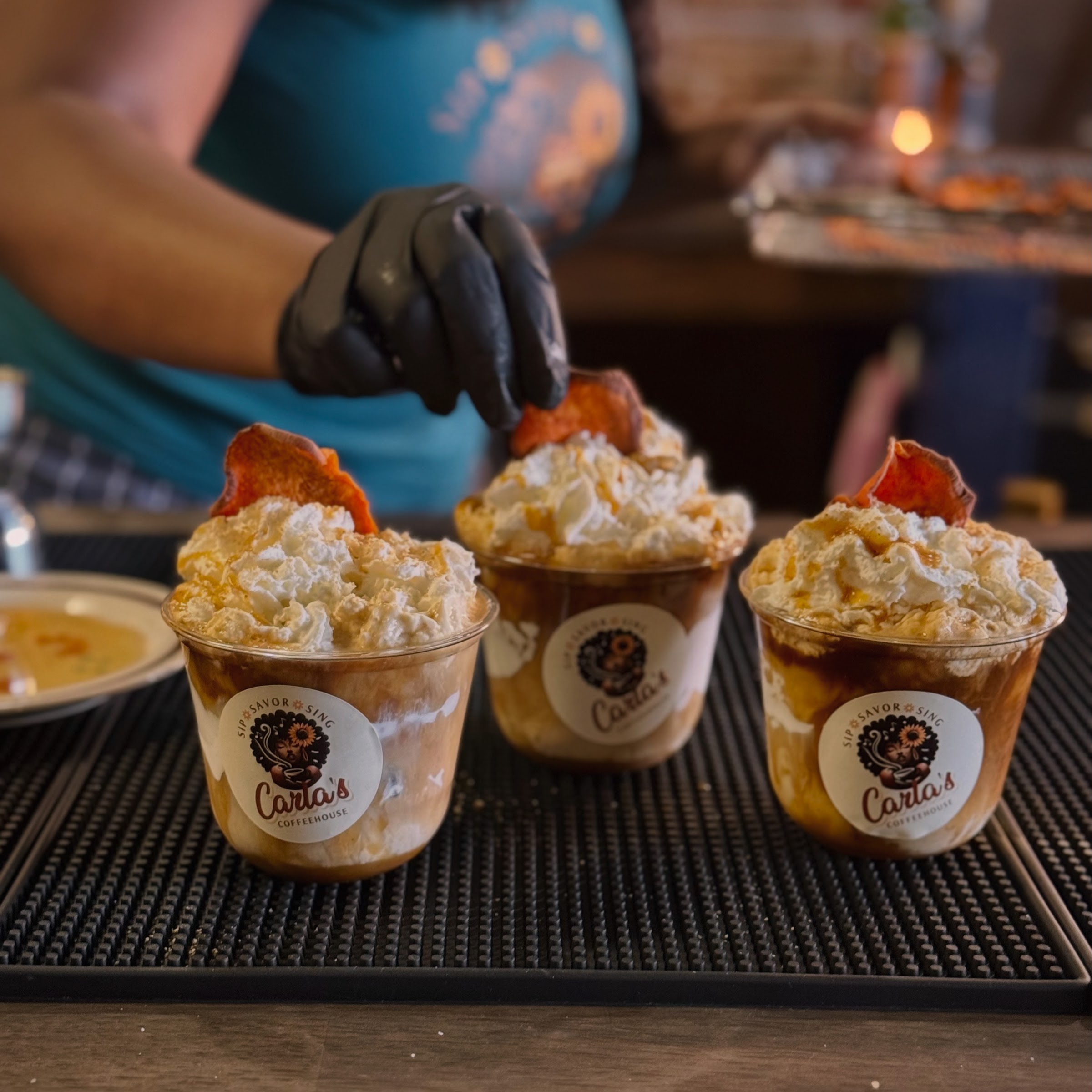 Carla's Coffeehouse drinks topped with whipped cream and sweet garnish